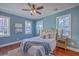 Serene blue bedroom with a ceiling fan, area rug, and natural light from three windows at 10 Humphrey Ct, Charleston, SC 29403