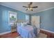 Tranquil bedroom with a ceiling fan, two windows, area rug, and decorative lamps at 10 Humphrey Ct, Charleston, SC 29403