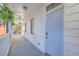 Inviting covered porch with a blue door, white railings, and green foliage at 10 Humphrey Ct, Charleston, SC 29403