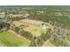 Expansive estate featuring a pond, pool, mature trees, and a private, tree-lined driveway at 1008 Hoodtown Rd, Bonneau, SC 29431