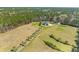 Expansive estate aerial view featuring a pond, surrounded by lush greenery and mature trees at 1008 Hoodtown Rd, Bonneau, SC 29431