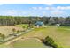 Expansive property featuring a charming two-story home, pond, and lush greenery from an aerial perspective at 1008 Hoodtown Rd, Bonneau, SC 29431
