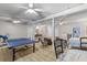 Spacious basement featuring a ping pong table, a bed, seating and a staircase at 1008 Hoodtown Rd, Bonneau, SC 29431