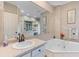 Well-lit bathroom with a soaking tub, tiled floors, and spacious vanity at 1008 Hoodtown Rd, Bonneau, SC 29431