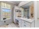 Bright bathroom with a large window, vanity area, and tiled walls at 1008 Hoodtown Rd, Bonneau, SC 29431