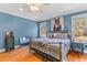 Cozy bedroom with hardwood floors, a decorative bed frame, and ample natural light at 1008 Hoodtown Rd, Bonneau, SC 29431
