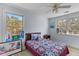 Bright bedroom with a ceiling fan, two large windows and colorful decor at 1008 Hoodtown Rd, Bonneau, SC 29431