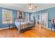 Bright bedroom featuring hardwood floors, a decorative bed frame, and plenty of natural light at 1008 Hoodtown Rd, Bonneau, SC 29431