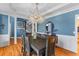 Elegant dining room with hardwood floors, blue walls, and a stunning chandelier at 1008 Hoodtown Rd, Bonneau, SC 29431