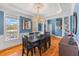 Elegant dining room featuring a dark wood table, ornate chandelier, and plenty of natural light at 1008 Hoodtown Rd, Bonneau, SC 29431