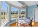 Charming dining room with large windows, chandelier, and serene view of the outside at 1008 Hoodtown Rd, Bonneau, SC 29431