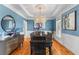 Stylish dining room with blue walls, a wooden table, and an elegant chandelier for gatherings at 1008 Hoodtown Rd, Bonneau, SC 29431