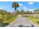 Long private driveway lined with mature palm trees and fenced pasture land in an expansive estate at 1008 Hoodtown Rd, Bonneau, SC 29431