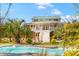 Beautiful home with a pool, lush landscaping and a white staircase at 1008 Hoodtown Rd, Bonneau, SC 29431