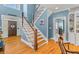 Grand foyer with a beautiful staircase, hardwood floors, and natural light at 1008 Hoodtown Rd, Bonneau, SC 29431