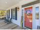 Inviting front porch with comfortable seating and charming decor at 1008 Hoodtown Rd, Bonneau, SC 29431