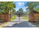 Grand gated entrance to estate with brick columns and long private driveway lined with mature trees at 1008 Hoodtown Rd, Bonneau, SC 29431