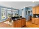 Well-lit kitchen with wooden cabinets, black countertops, island stovetop, and breakfast nook at 1008 Hoodtown Rd, Bonneau, SC 29431