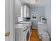 Bright laundry room with white cabinets, washer, dryer, and hardwood floors at 1008 Hoodtown Rd, Bonneau, SC 29431