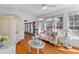 Inviting living room featuring a cozy couch, hardwood floors, and abundant natural light at 1008 Hoodtown Rd, Bonneau, SC 29431