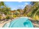 Backyard pool surrounded by palm trees and fencing, offering a private and tropical escape at 1008 Hoodtown Rd, Bonneau, SC 29431
