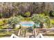 Aerial view of the backyard pool with a pergola, surrounded by mature trees and landscaping at 1008 Hoodtown Rd, Bonneau, SC 29431