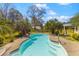 Well-kept backyard pool with stairs, surrounded by mature landscaping and a charming fence at 1008 Hoodtown Rd, Bonneau, SC 29431