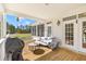 Relaxing covered porch with grill, comfortable seating, and views of the lush yard at 1008 Hoodtown Rd, Bonneau, SC 29431
