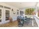 Covered porch with wood flooring, a dining table and chairs, perfect for outdoor dining at 1008 Hoodtown Rd, Bonneau, SC 29431
