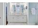 Elegant bathroom featuring double sink vanity with white cabinets, marble countertop and framed mirrors at 1014 Bradbury Ln, Charleston, SC 29492