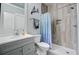Modern bathroom featuring a shower with wood-look tile, a stylish vanity, and contemporary fixtures at 1014 Bradbury Ln, Charleston, SC 29492
