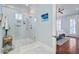 Contemporary bathroom with a frameless glass shower, white marble tile, and doorway to main bedroom at 1014 Bradbury Ln, Charleston, SC 29492
