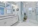 Bright bathroom featuring double sinks with marble countertop and walk-in shower with clear glass door at 1014 Bradbury Ln, Charleston, SC 29492