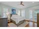 Serene bedroom with hardwood floors, ceiling fan, a queen-size bed, and a view of the exterior at 1014 Bradbury Ln, Charleston, SC 29492