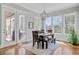 Sunlit dining area featuring a rustic table, bench, and glass doors to the outside at 1014 Bradbury Ln, Charleston, SC 29492