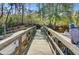Dock with a wooden railing, boat, and other watercrafts, perfect for enjoying waterfront living at 1014 Bradbury Ln, Charleston, SC 29492