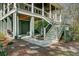 Home exterior showcasing a well-maintained yard, staircase, and outdoor living spaces with a relaxing atmosphere at 1014 Bradbury Ln, Charleston, SC 29492