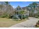 Inviting home exterior featuring a landscaped yard, a graceful palm tree, and a spacious driveway at 1014 Bradbury Ln, Charleston, SC 29492