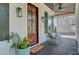 Cozy front porch with a wooden door, stylish lighting, and comfortable seating area at 1014 Bradbury Ln, Charleston, SC 29492