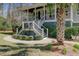Close up of a landscaped front yard with a well-manicured lawn and a charming home entrance at 1014 Bradbury Ln, Charleston, SC 29492