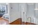 Hallway featuring hardwood floors, white wainscotting, and access to staircase and bedroom at 1014 Bradbury Ln, Charleston, SC 29492