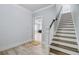 Hallway showcasing light-colored wood floors, a white staircase, and an open doorway at 1014 Bradbury Ln, Charleston, SC 29492
