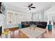 Open-concept living room with hardwood floors, a ceiling fan, and bright natural light at 1014 Bradbury Ln, Charleston, SC 29492