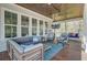 Relaxing covered porch with comfortable seating, a ceiling fan, and a mounted TV for outdoor enjoyment at 1014 Bradbury Ln, Charleston, SC 29492