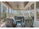 Charming porch featuring comfortable chairs, a coffee table, and views of the surrounding trees and backyard at 1014 Bradbury Ln, Charleston, SC 29492