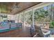Inviting porch area with stylish seating, a view of the wooded backyard, and a cozy atmosphere at 1014 Bradbury Ln, Charleston, SC 29492