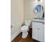 Compact powder room with wood floors, modern fixtures, and a stylish mirror at 1014 Bradbury Ln, Charleston, SC 29492