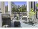 Relaxing outdoor balcony featuring comfortable seating, a glass coffee table, and charming plants at 1025 Riverland Woods Pl # 609, Charleston, SC 29412