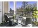 Cozy balcony with comfortable seating, a small glass table, and a view of the surrounding neighborhood at 1025 Riverland Woods Pl # 609, Charleston, SC 29412