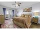 Primary bedroom features a ceiling fan, hardwood floors, and access to a private balcony at 1025 Riverland Woods Pl # 609, Charleston, SC 29412